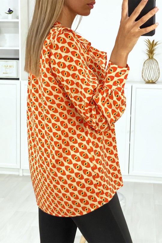 Blouse à motif orange avec volant à l'avant